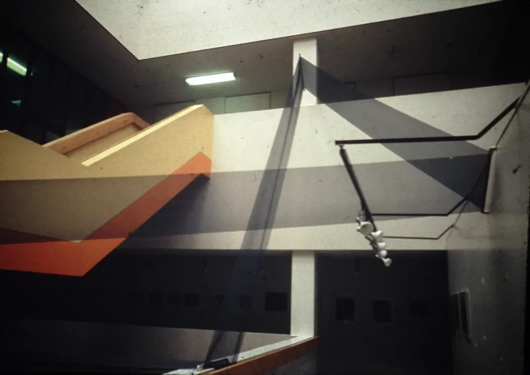 photograph between floors of a building with a staircase to the left.