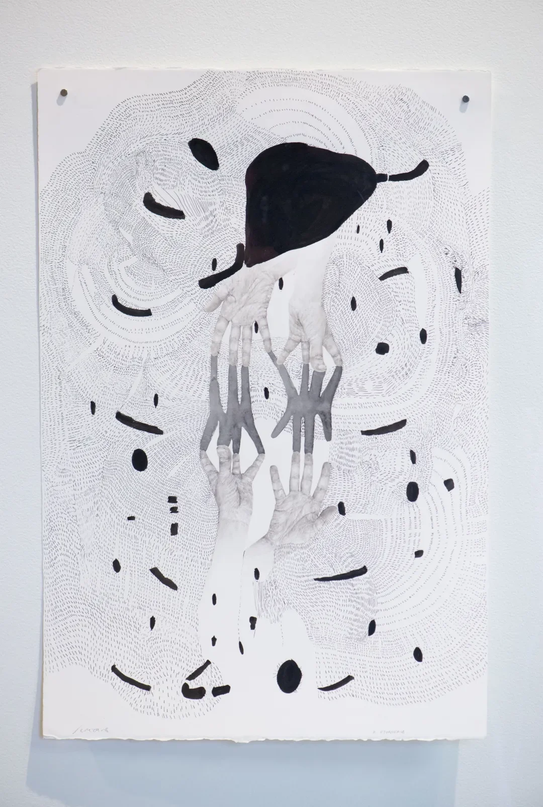 A black and white art piece featuring hands reaching upward, with some hands holding a black shape resembling a bird or abstract form. The background consists of intricate line patterns and scattered black ovals.