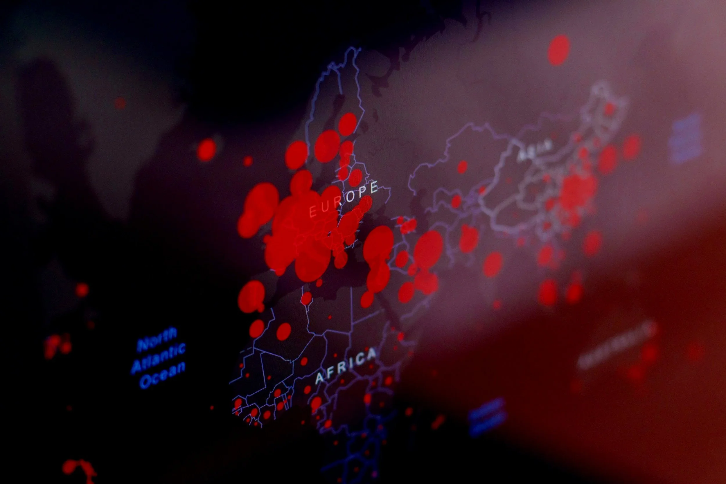 A digital map showing red circles representing data points across Europe, Africa, and the North Atlantic Ocean on a dark background.