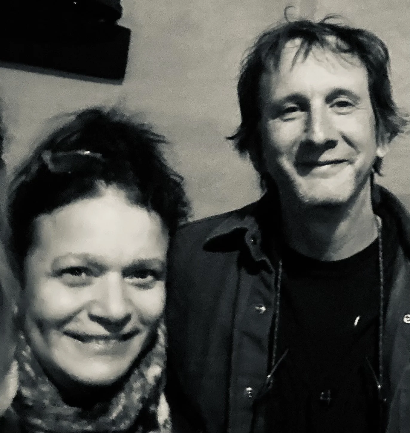 A close-up black-and-white photo of Monique King and Paul Rosenbluh, both smiling.