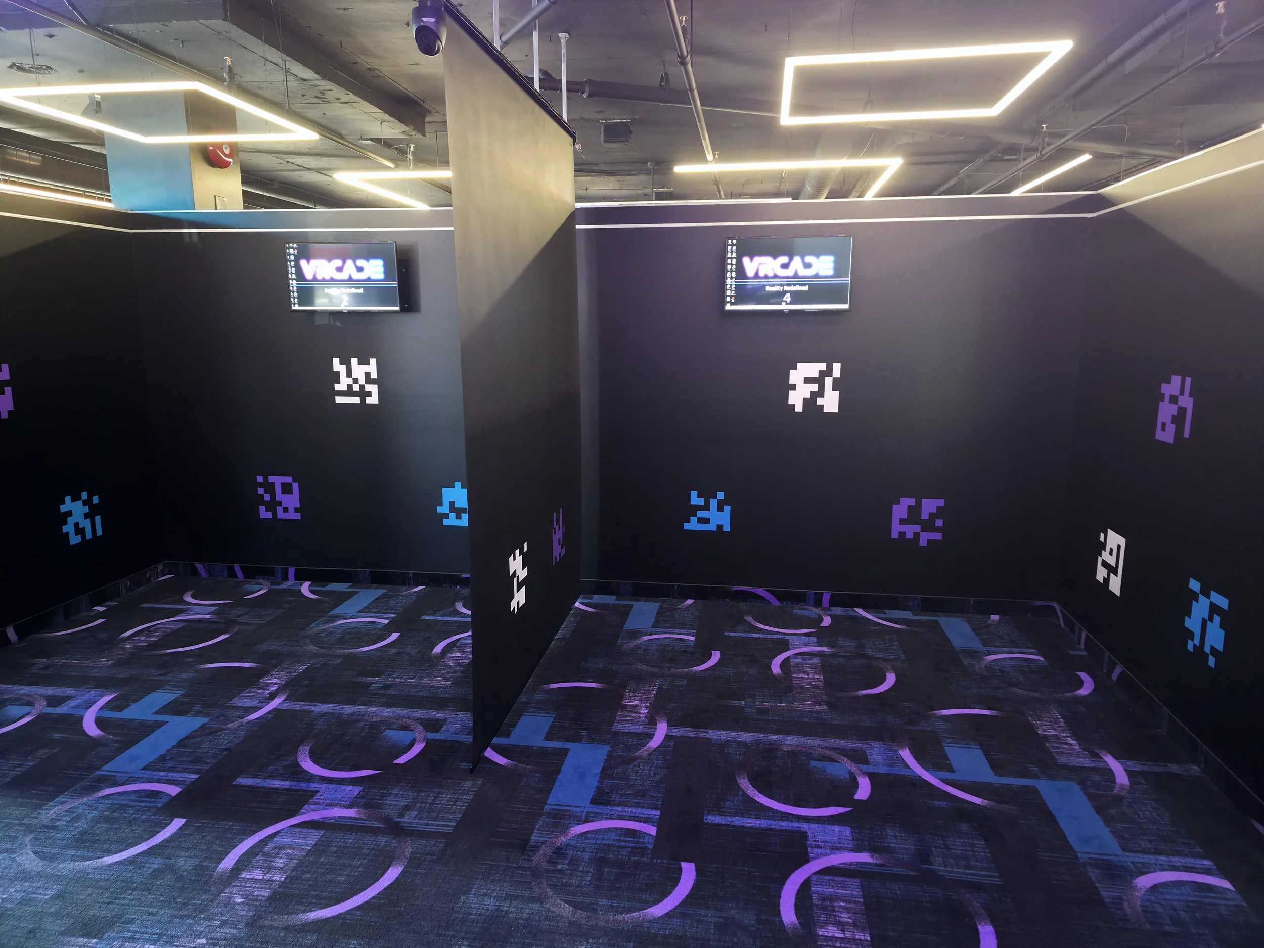 Stand-alone VR gaming stations at VRCADE Toronto with individual play spaces and screens