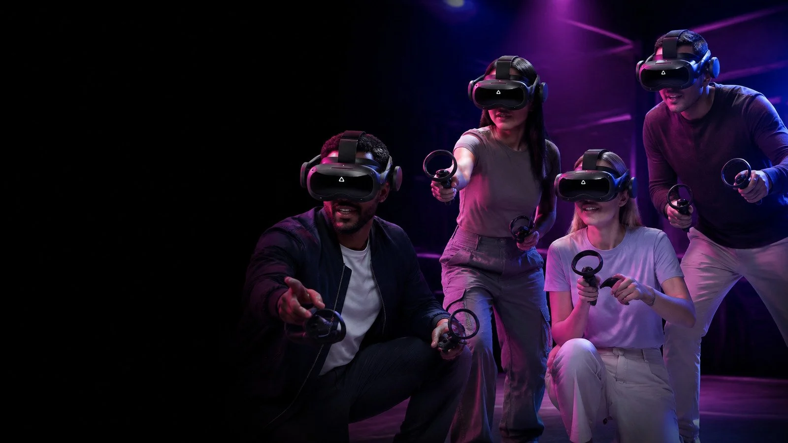 Coworkers using black HTC VIVE Focus 3 headsets and black controllers during a Toronto VR team-building event.