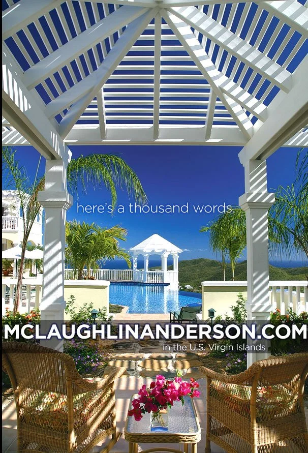 View of a luxurious pool area with a gazebo and palm trees, seen from under a white pergola, with the sky and distant mountains in the background. Text reads: 'here's a thousand words' and 'McLaughlinAnderson.com in the U.S. Virgin Islands'.