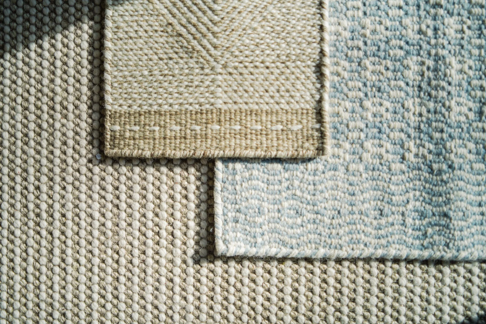 Close-up of woven fabric swatches in layered neutral textures