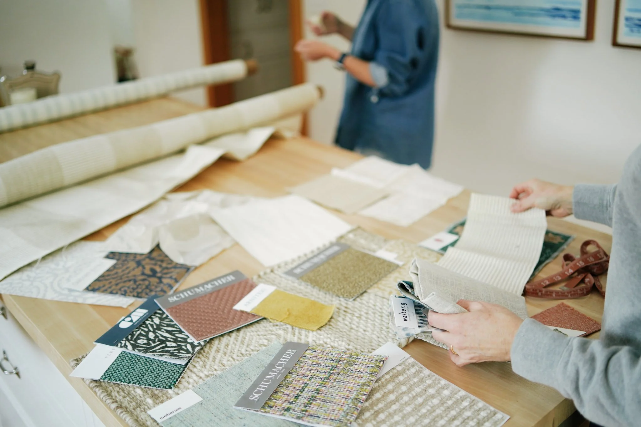 Kate and Newell of Brookfield Hunt Studio reviewing fabric swatches and paint samples together