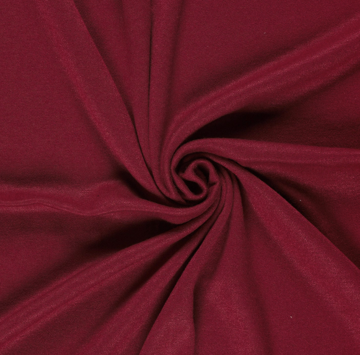 Close-up of red fabric twisted in a spiral pattern.