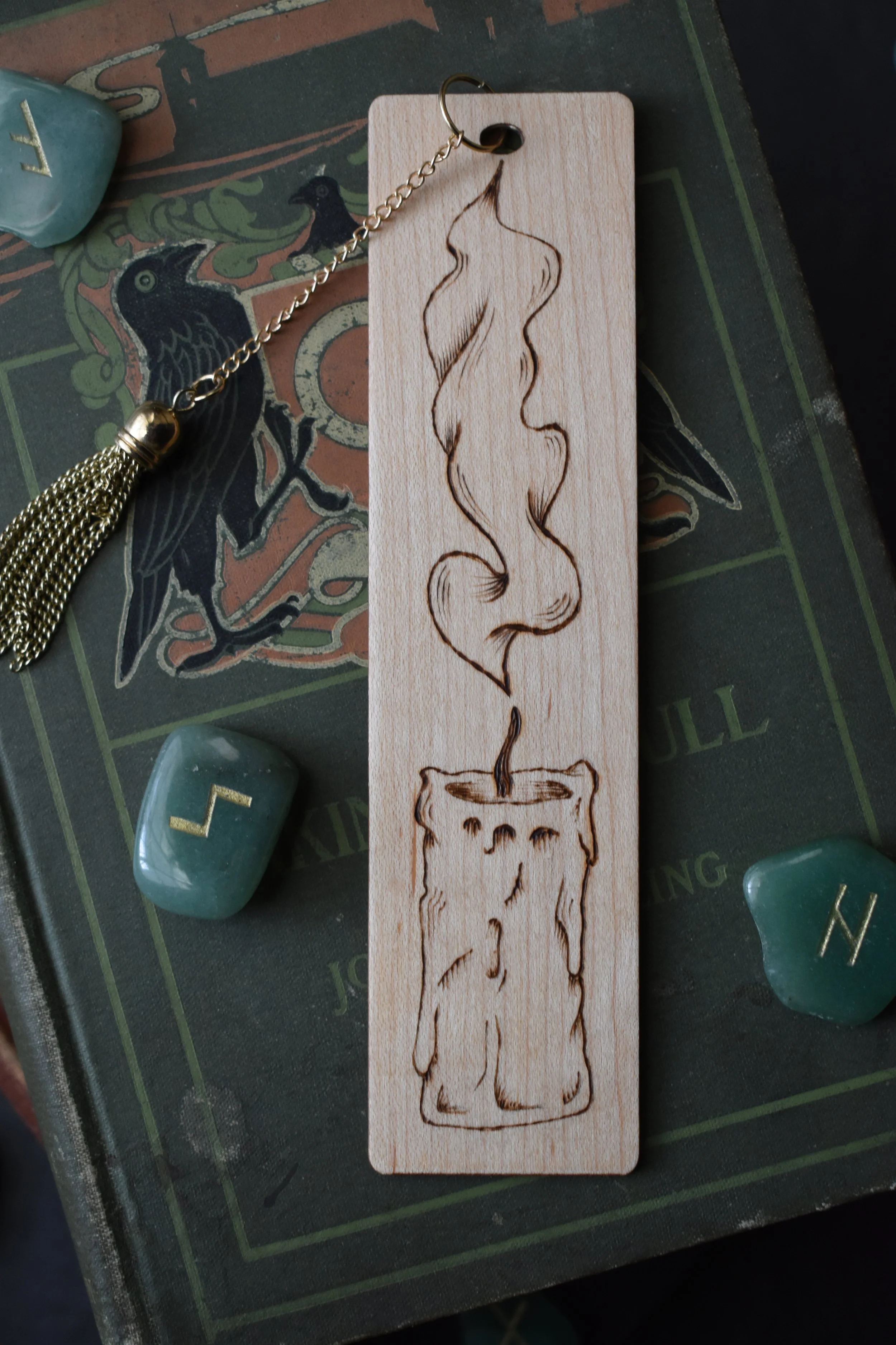 Handmade wood-burned bookmark with detailed candle flame and smoke design, featuring vintage medieval-inspired artwork.