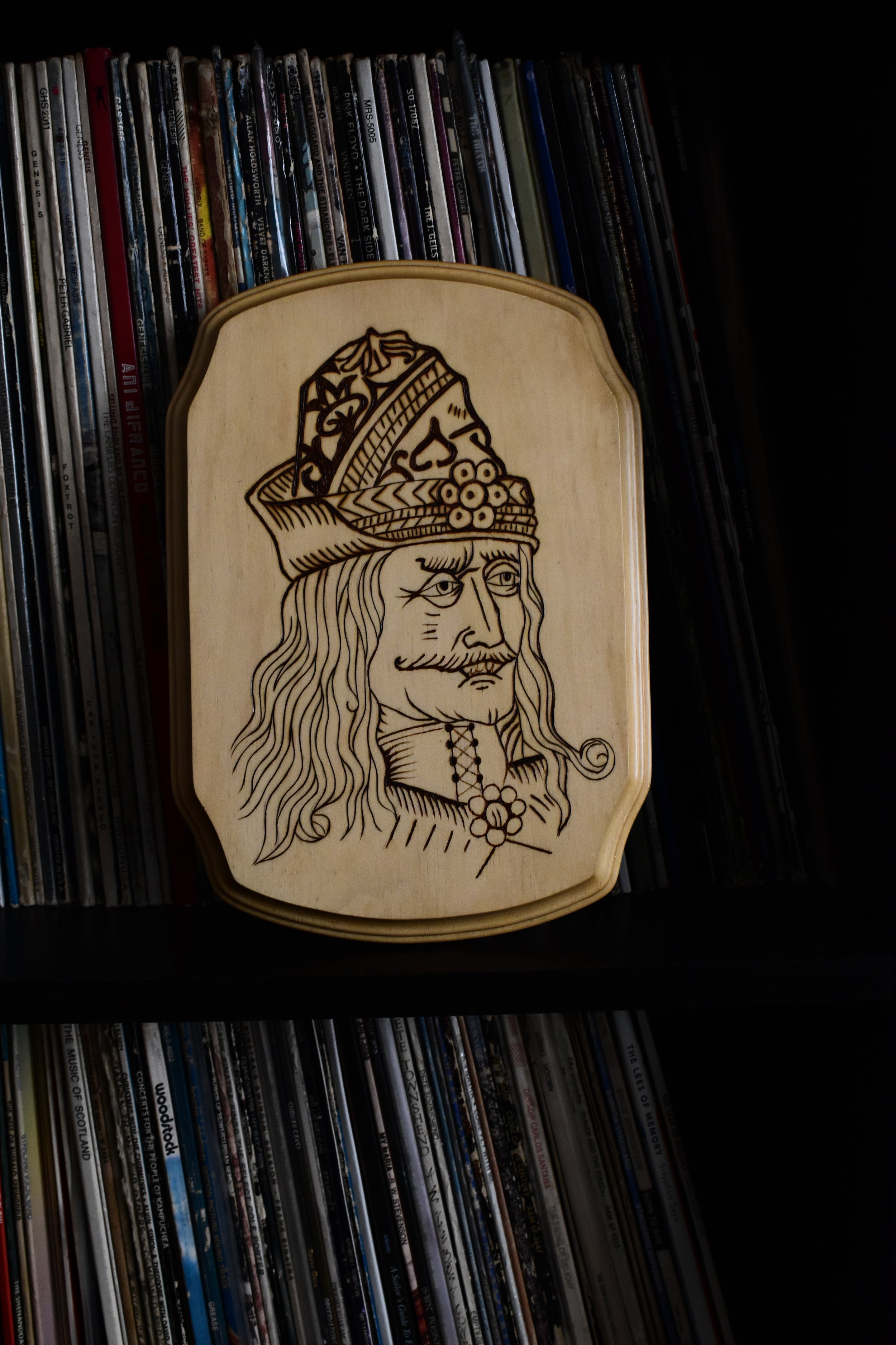 Handcrafted wood-burned portrait of Vlad the Impaler, inspired by a 15th-century engraving, on basswood.