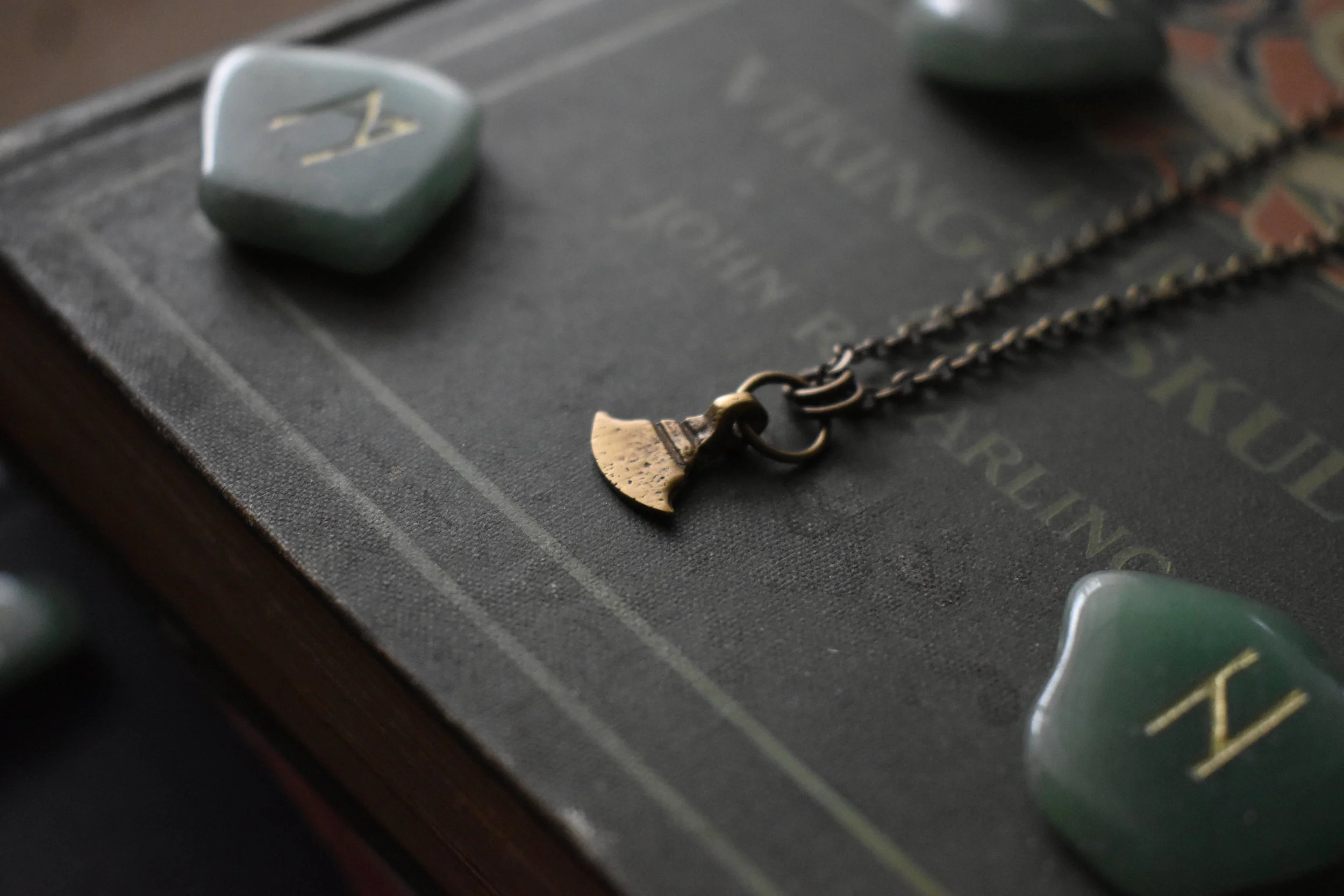 Handmade Axeblade Necklace featuring a small hand axe blade charm in antiqued brass on an 18-inch chain