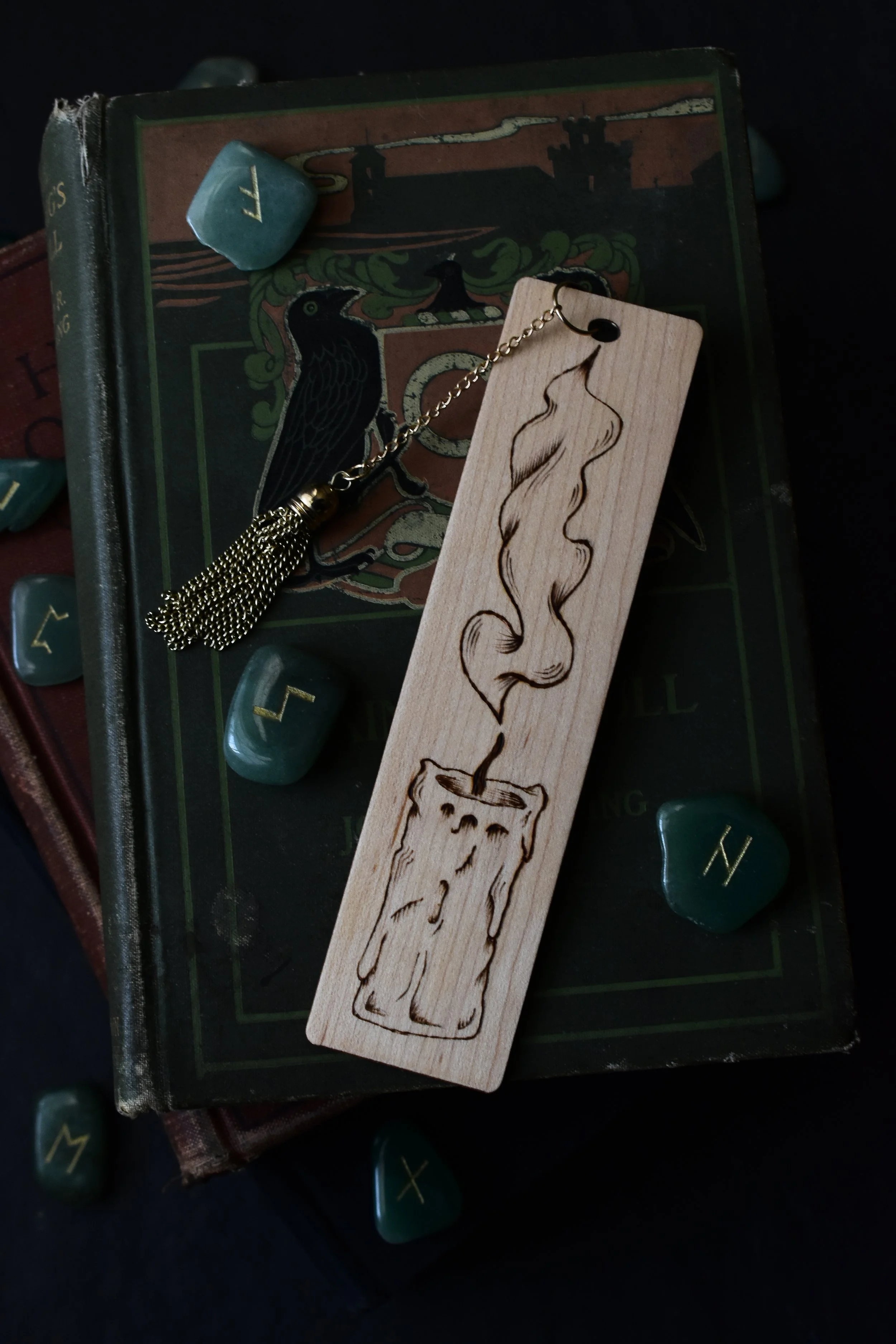 Handmade wood-burned bookmark with detailed candle flame and smoke design, featuring vintage medieval-inspired artwork.