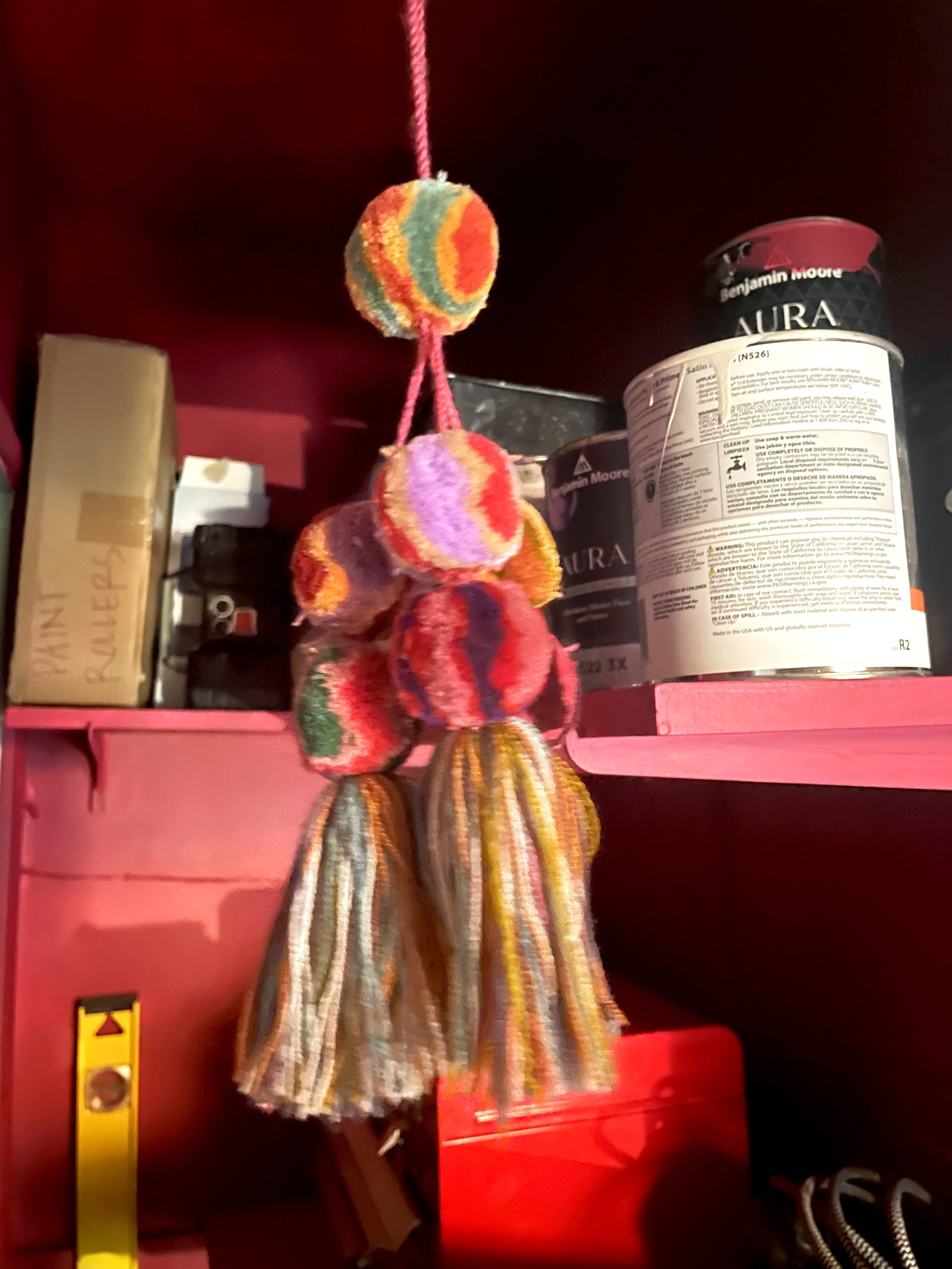 It's like Victoria's Secret. Demure on the surface and rainbow in the utility closet. Fun pompom tassel from Mexico replaced the light pull.