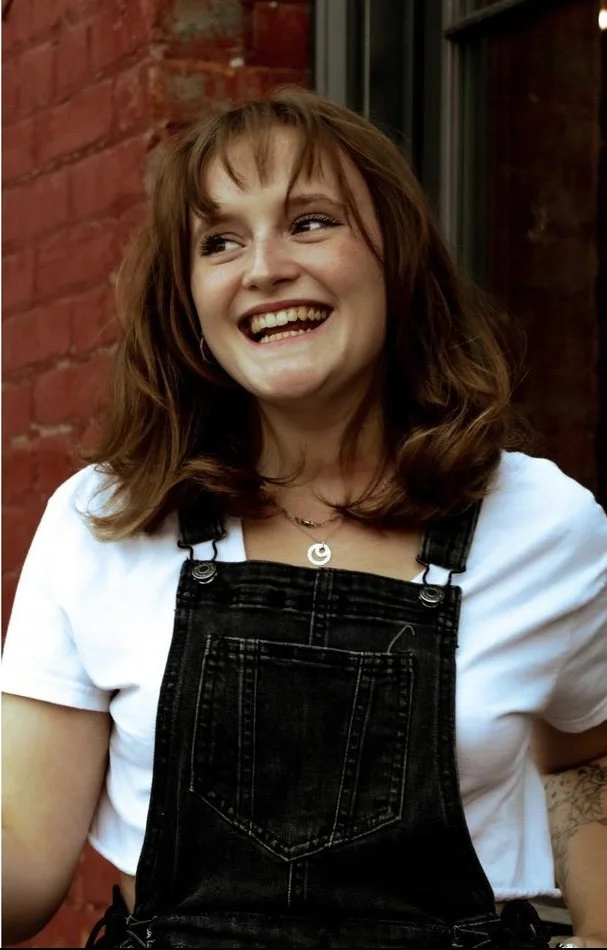 A woman with bangs laughing