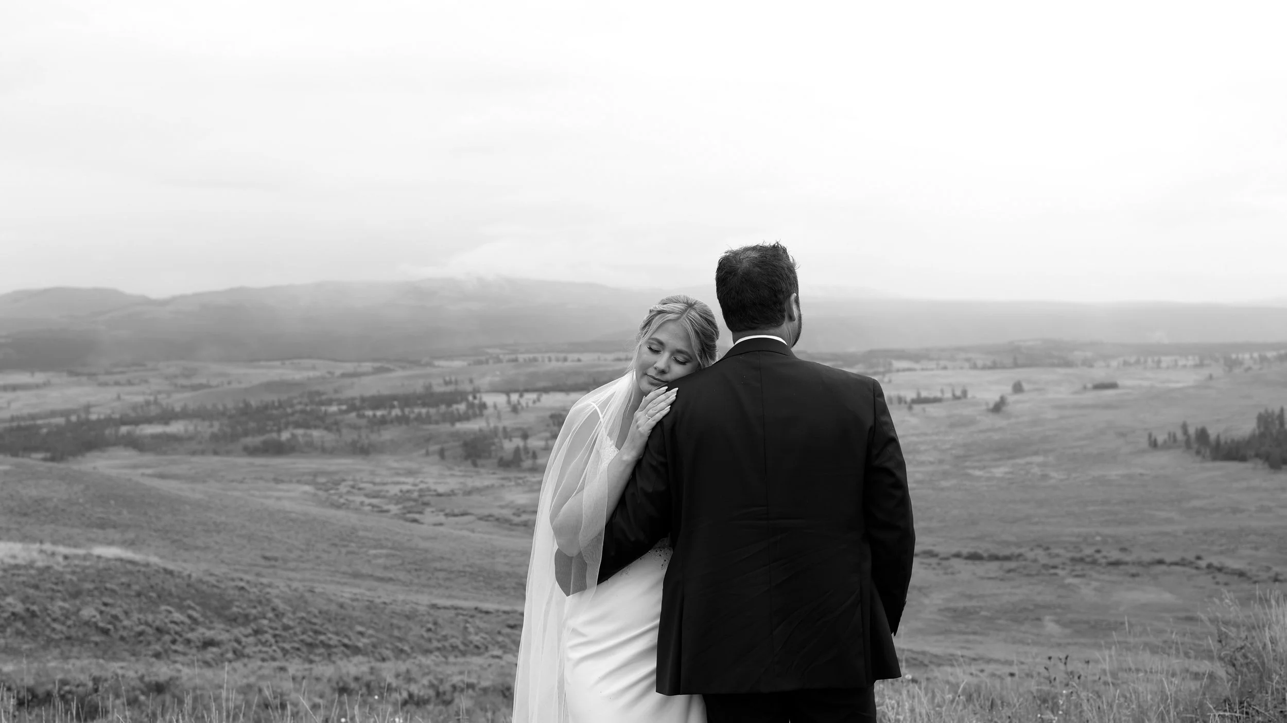 A newly married couple share a sweet moment, taking in a beautiful Montana landscape in Yellowstone National Park