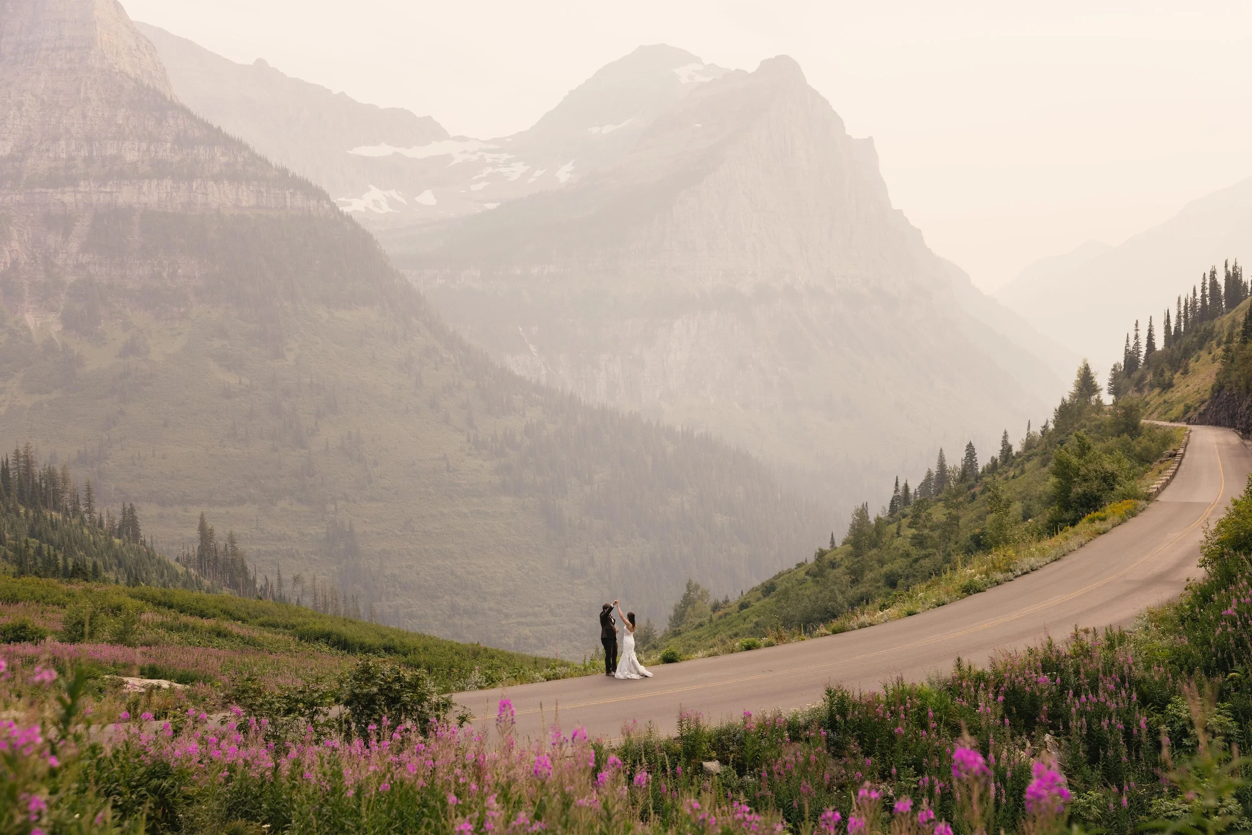 A couple dances in the road at Big Bend in Glacier National Park