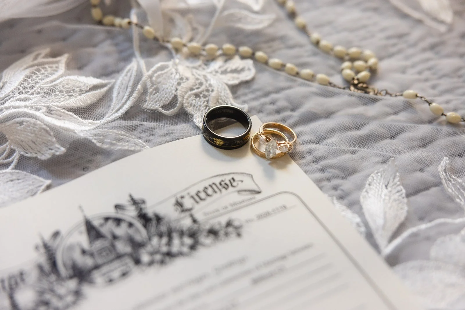 Close up of wedding rings on top of a Montana marriage license.