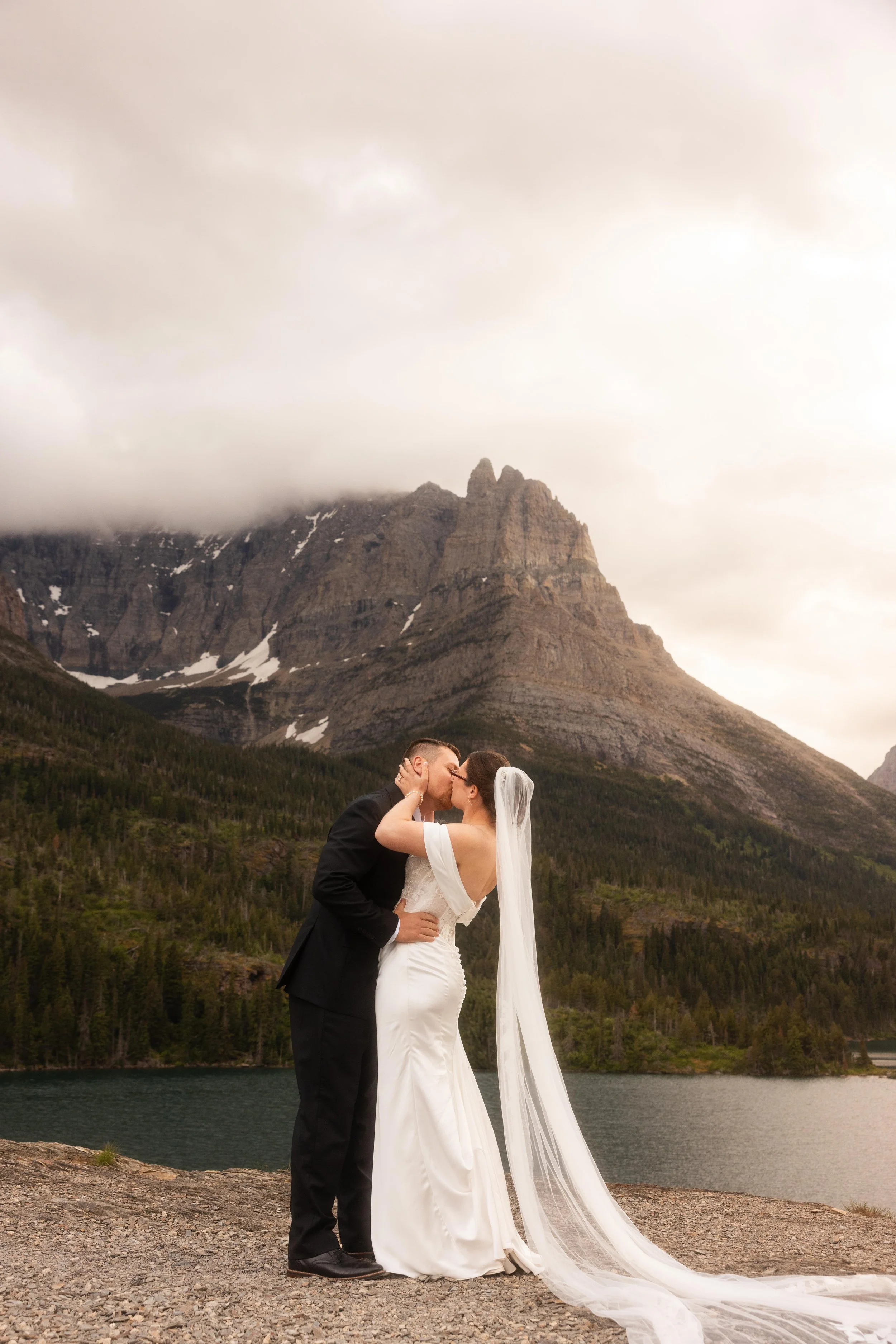 The first kiss at a scenic wedding at Sun Point in Glacier National Park