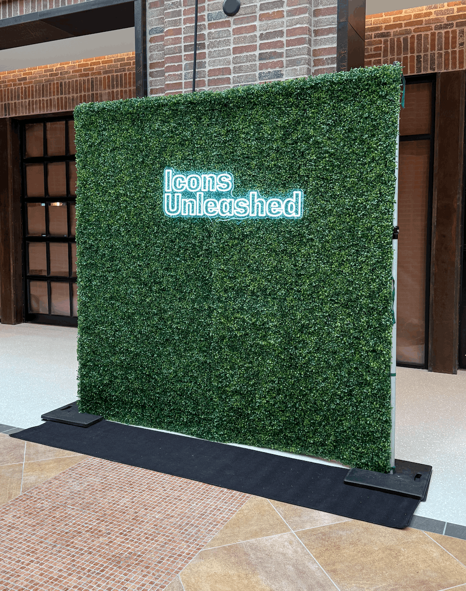 8x8ft artificial hedge wall with neon signage, heavy-duty greenery backdrop for indoor and outdoor event rentals, professional-grade faux boxwood panels.