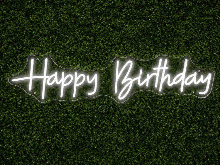 Happy Birthday white LED neon sign rental on clear acrylic displayed on a boxwood wall in Nashville