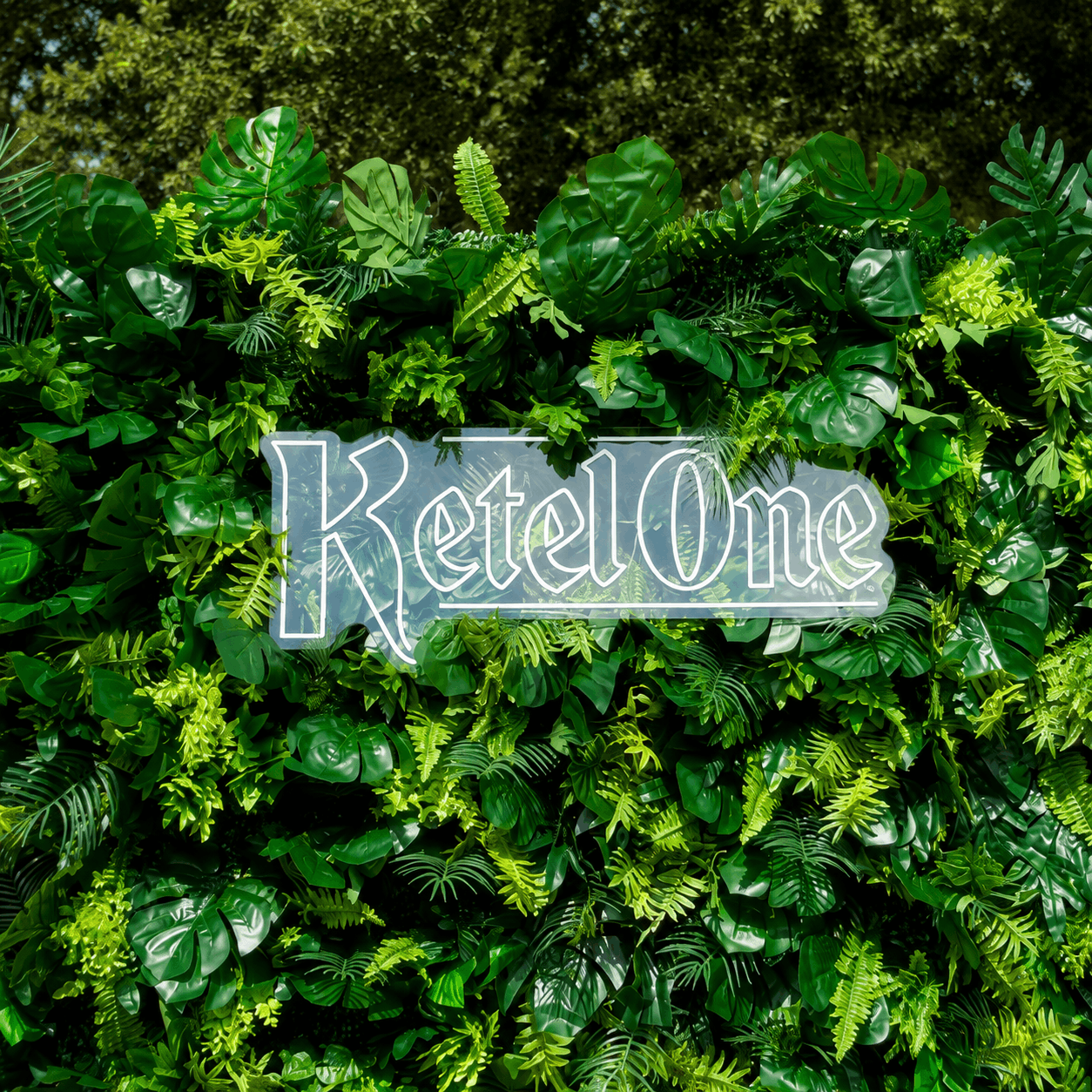 Custom Ketel One neon sign on a tropical greenery wall for a Nashville brand activation event
