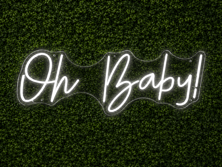 Oh Baby white LED neon sign rental on clear acrylic displayed on a boxwood wall for a Nashville event