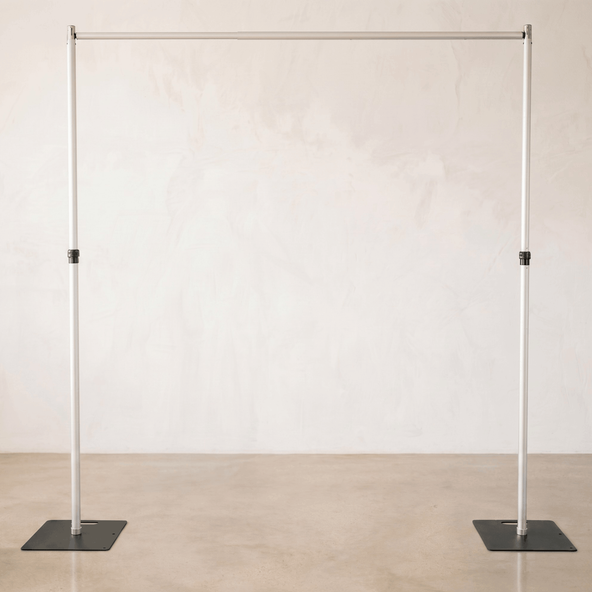 Adjustable aluminum backdrop stand kit for event rentals and weddings, sturdy pipe and drape hardware collection for supporting floral walls and fabric curtains.