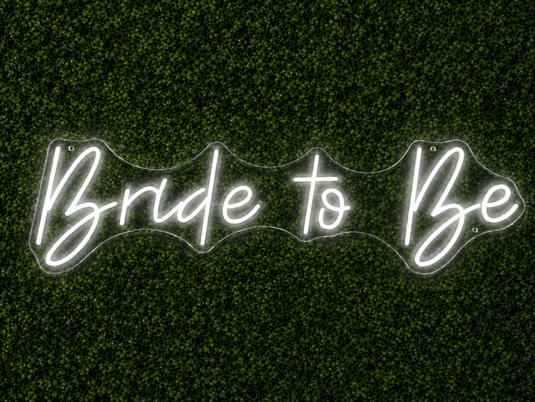 Bride to Be white LED neon sign rental on clear acrylic displayed on a boxwood wall in Nashville
