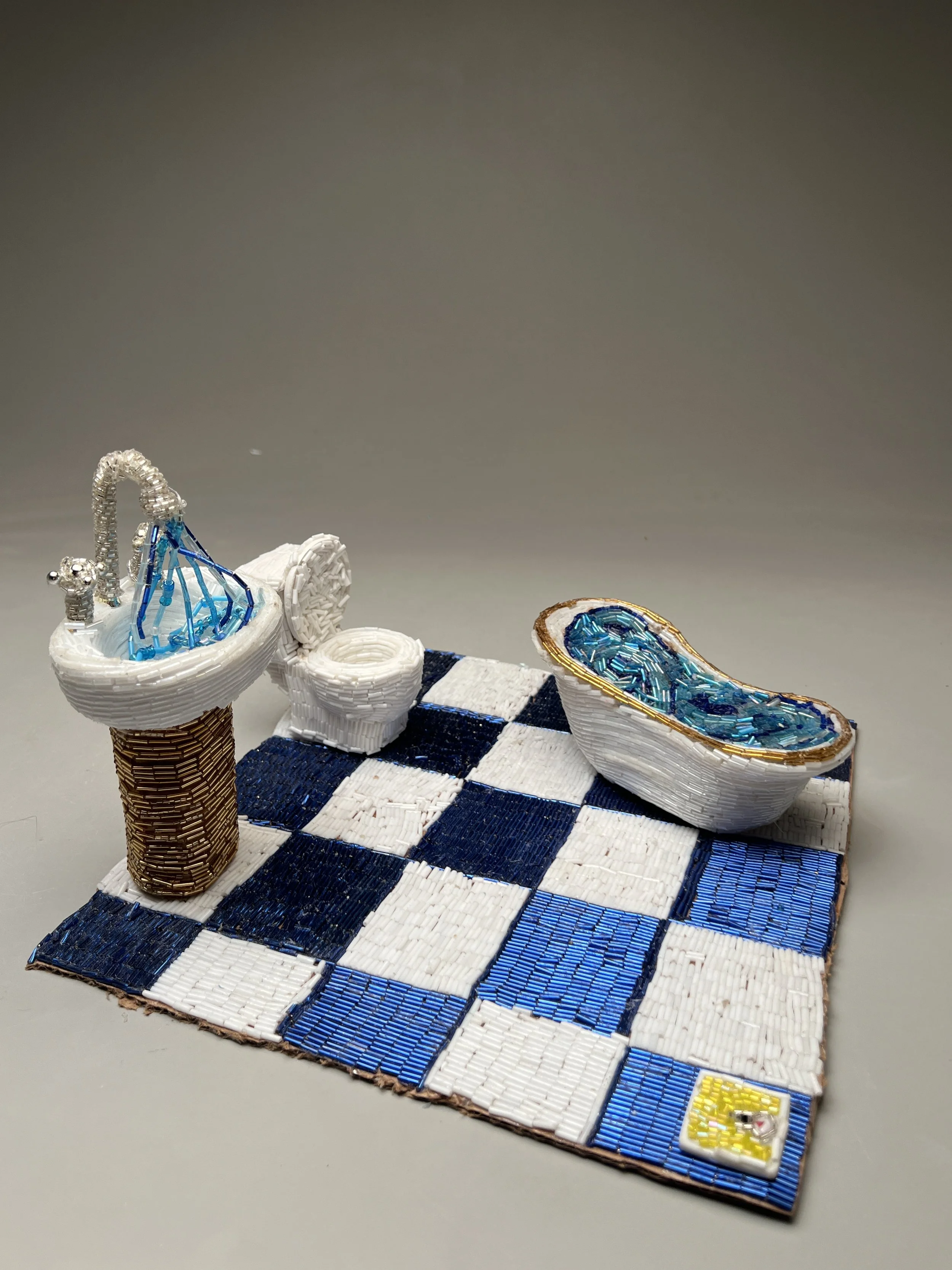 Bathroom Still Life, 12”x12”, cardboard, glass beads, clay, resin, 2024