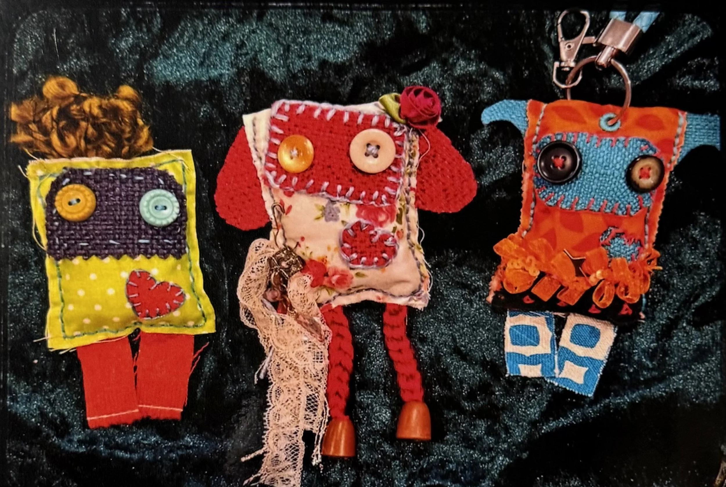 Nova Myles - Three's Company (2026) - Thrifted scrap fabrics and thread - These three Pogos (Pocket Goblins) represent myself, my partner and our best friend. Each Pogo is carefully crafted to encapsulate how I see them, and hand stitched with love.