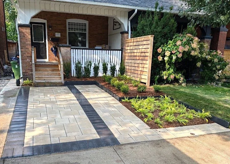 Modern Toronto parking pad built with permeable pavers and reinforced cement edge restraint for strength and stability.