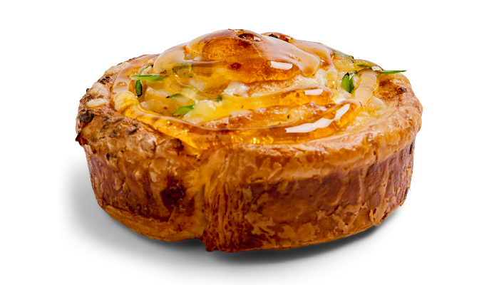 Open-faced breakfast bread with fried egg, cheese, and green onions