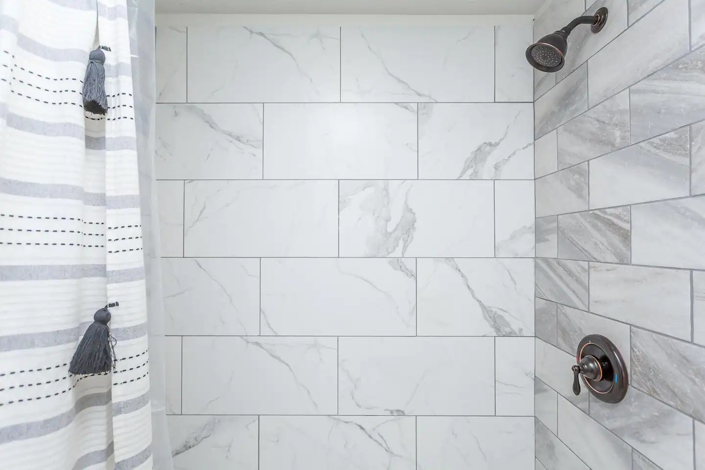 Lower level bathroom. Marble tiled shower.
