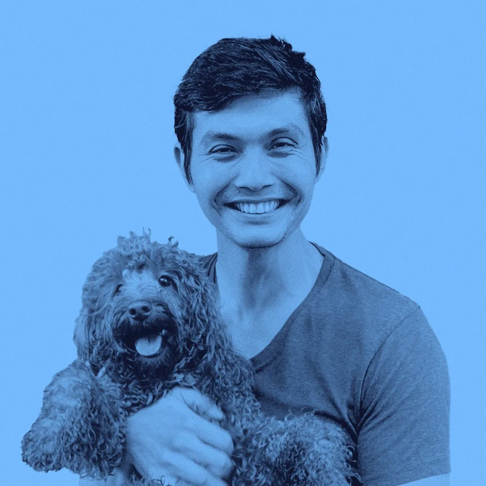 Gabriel Guedes, COO at Pet Longevity Institute, wearing a t-shirt and posing with a Cavoodle Dog, representing expertise in pet health and longevity