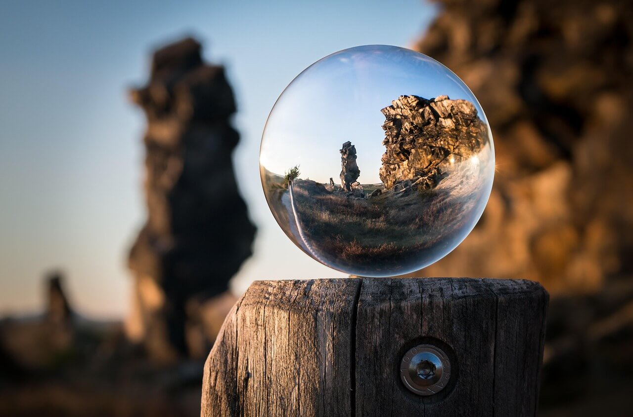 Glass sphere magnifying mountains