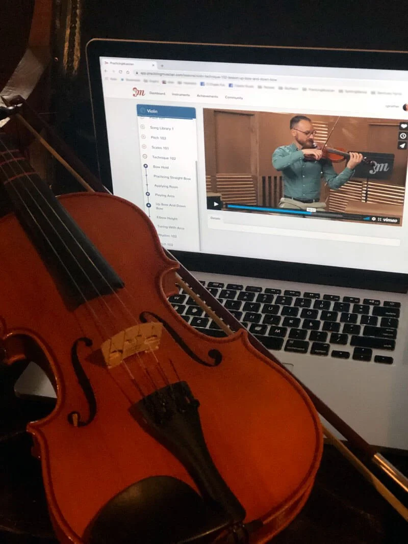 Violin with Practicing Musician on computer