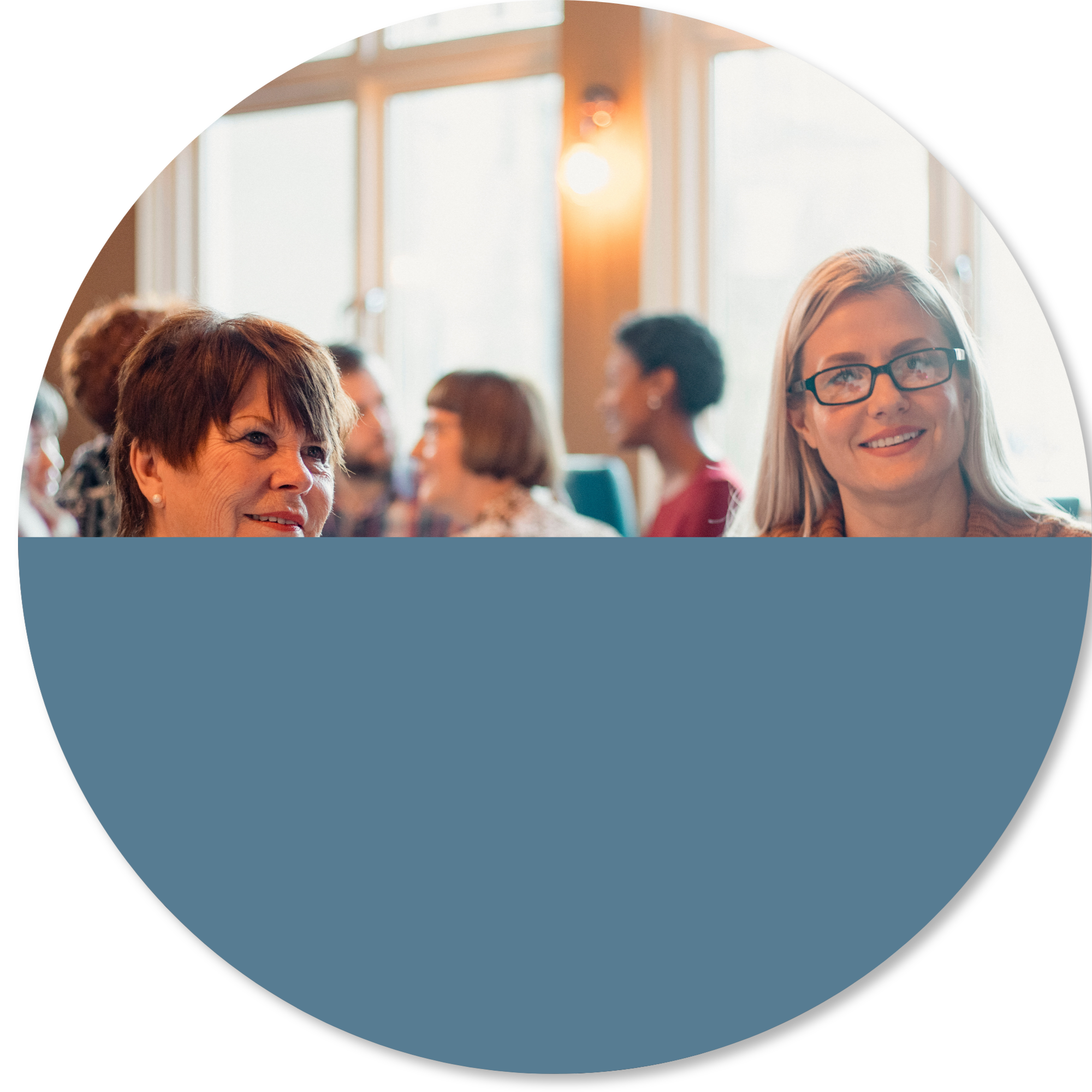 Group of adults socialising and connecting in a warm community setting, representing rebuilding social connection, confidence, participation, and support after illness, fatigue, or neurological challenges.