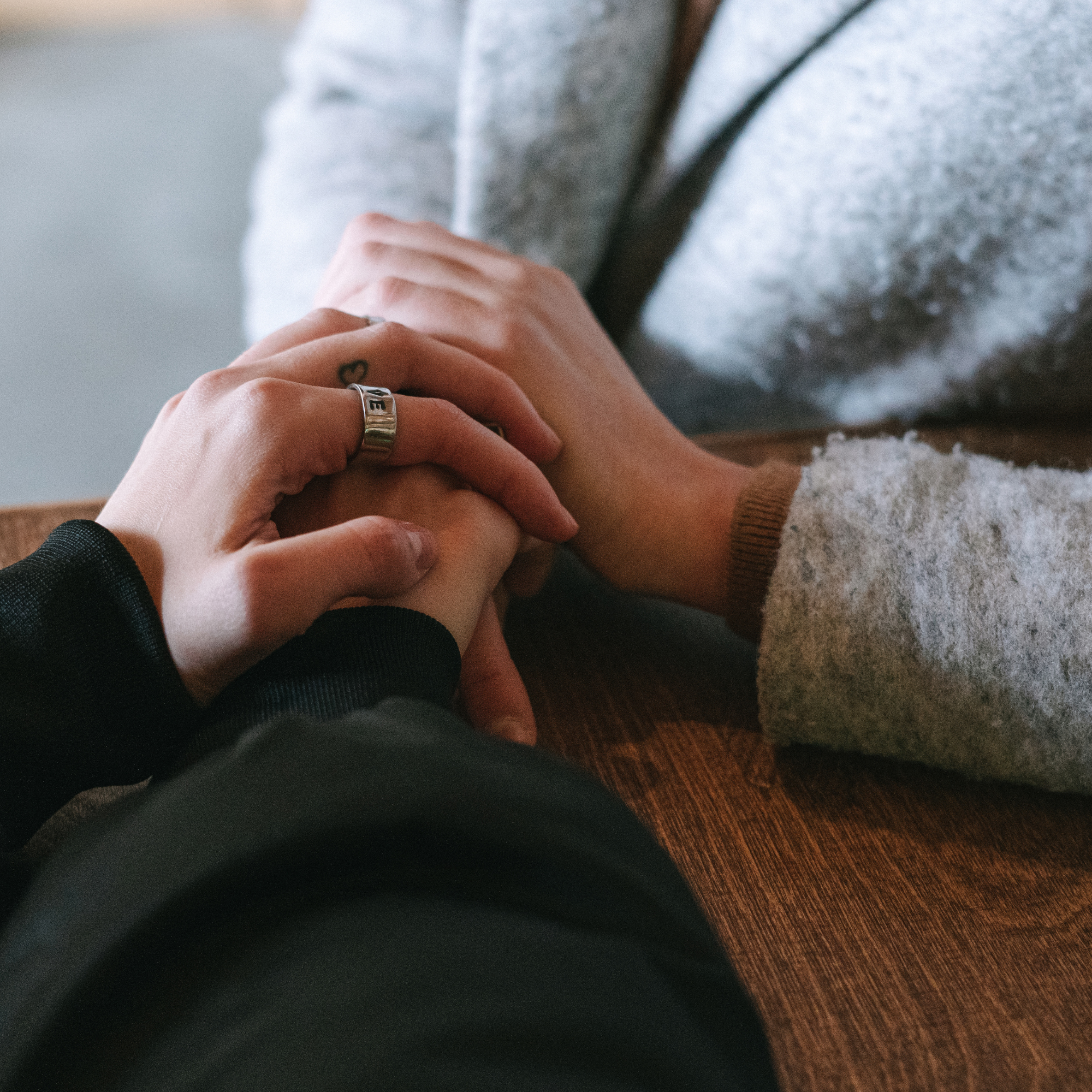 Supportive hands representing compassionate care and occupational therapy support for people living with persistent pain