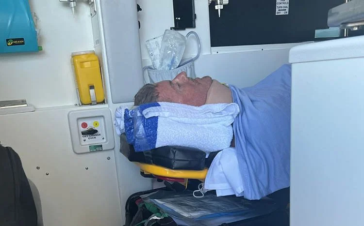 A man being transferred by ambulance after sustaining a cervical spinal cord injury, marking the beginning of his recovery journey.