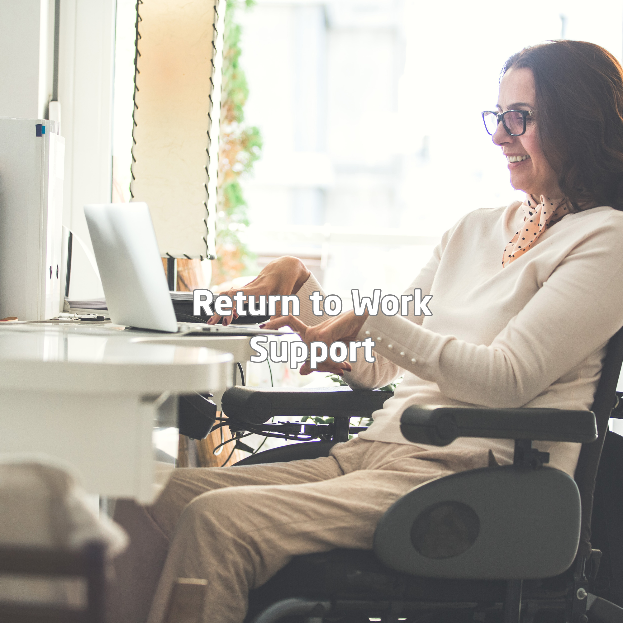 Woman using a wheelchair confidently working on a laptop in an accessible home office environment