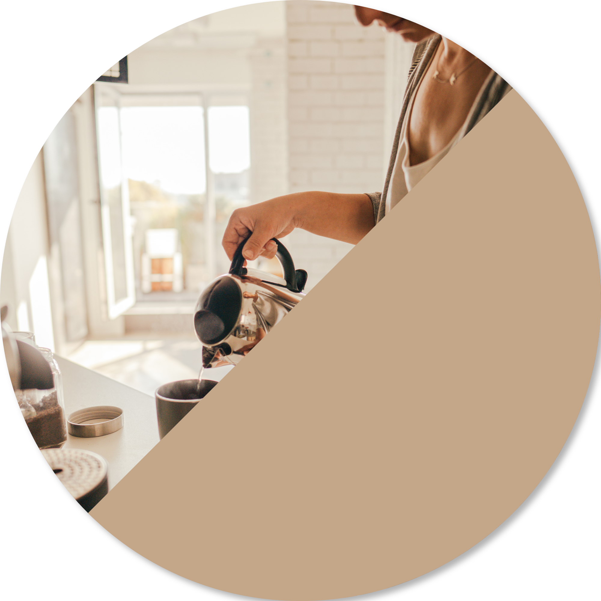 A woman in a beige top and gray cardigan pouring coffee from a pot into a black mug in a kitchen with light-colored walls and cabinets, with sunlight coming through a window.