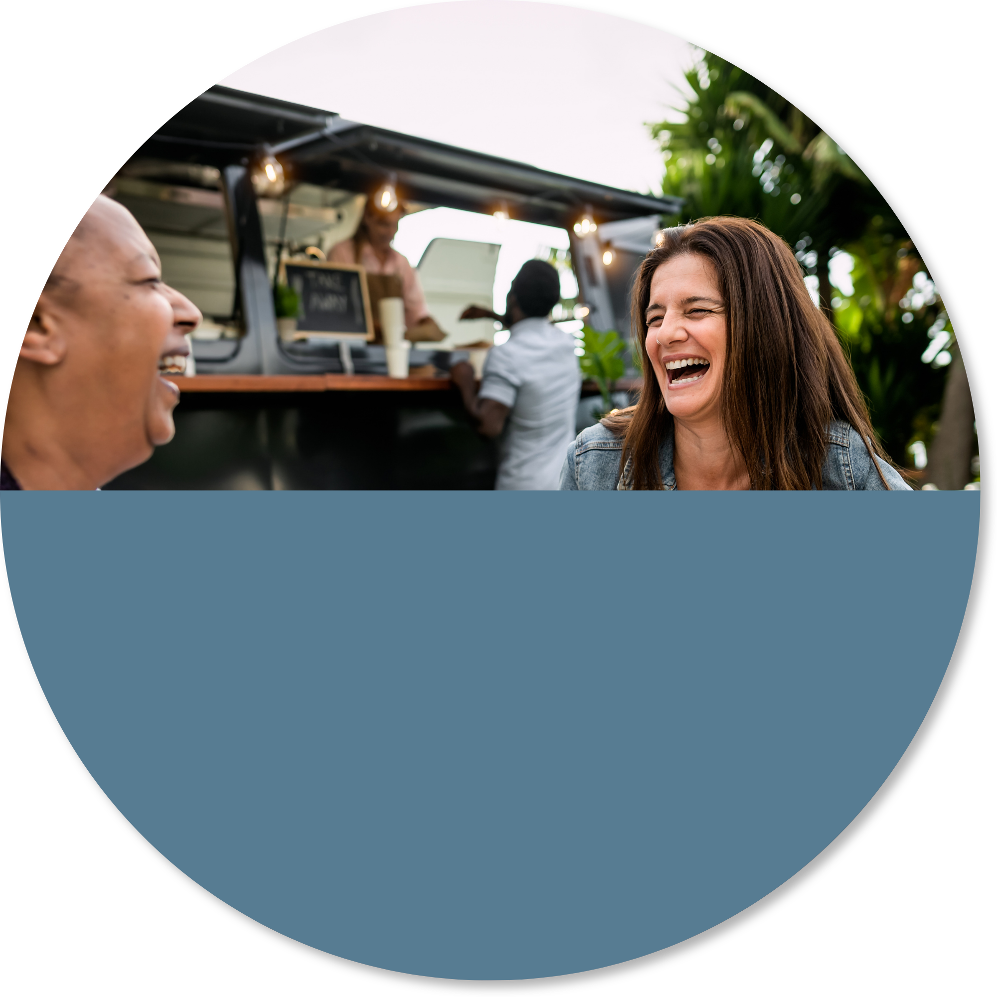 People laughing together at an outdoor café, representing social connection, community participation, and returning to meaningful activities after stroke.