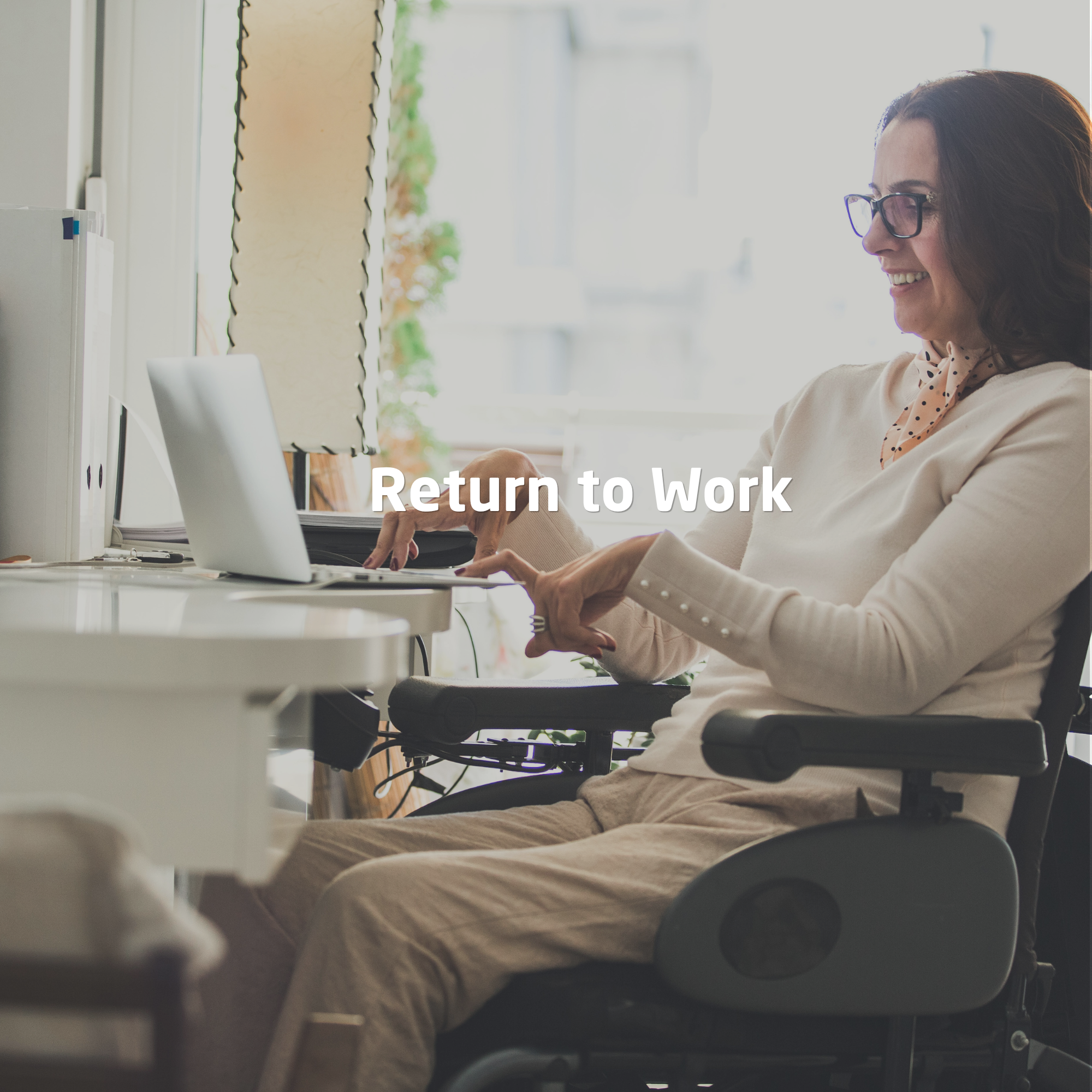 Woman using a wheelchair confidently working on a laptop in an accessible home office environment.