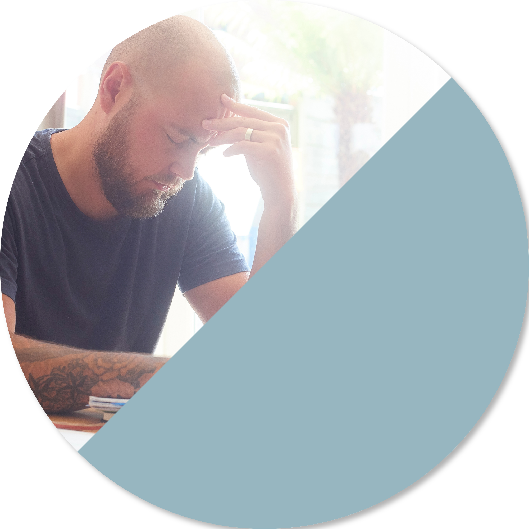 Person sitting at a table with head in hand, appearing mentally and physically fatigued while managing everyday tasks, representing the challenges of regaining independence in daily activities after illness or neurological injury.