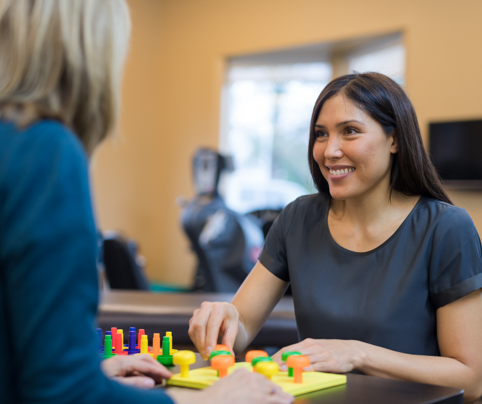 A woman playing a game or doing a puzzle with colourful pieces