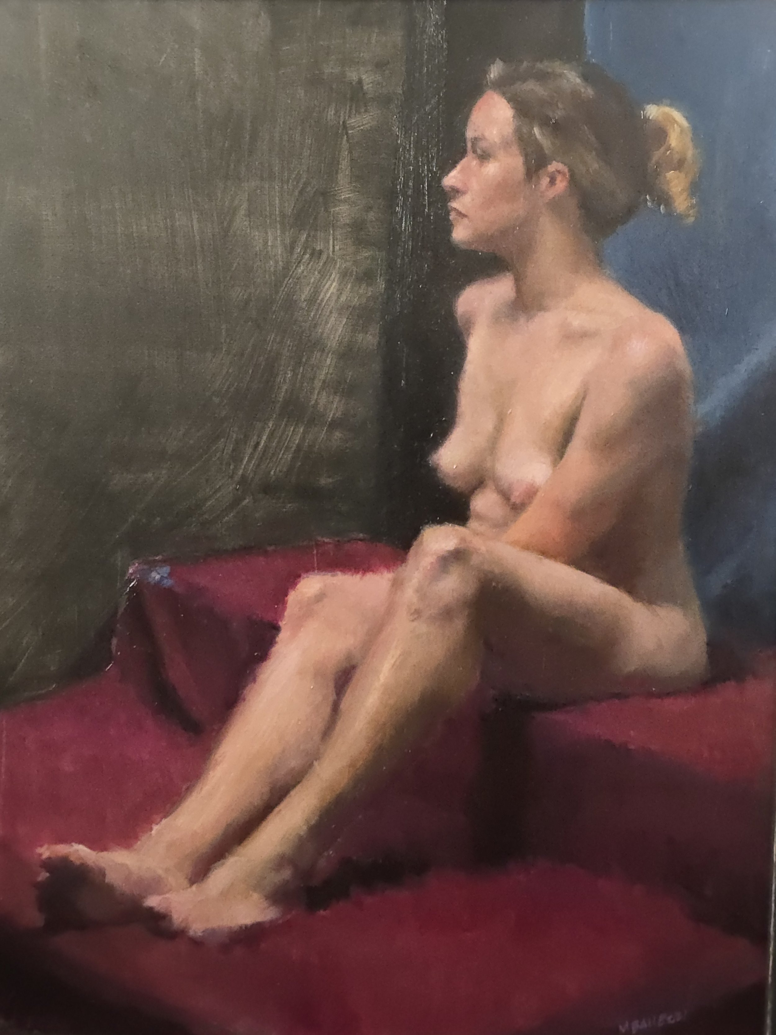 Student Work from Art Class. Oil painting of a nude woman with light skin, seated on a red surface, with a dark background, in a contemplative pose.