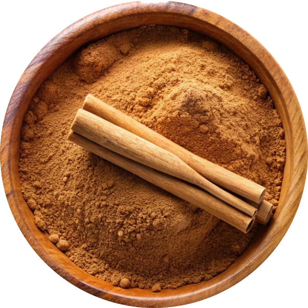 A wooden bowl filled with ground cinnamon and two cinnamon sticks resting on top.