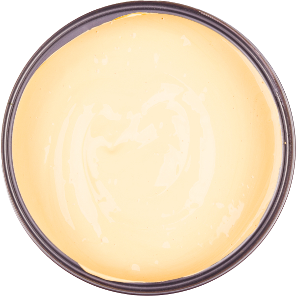 An open container with a smooth, creamy, yellow batter or custard inside.