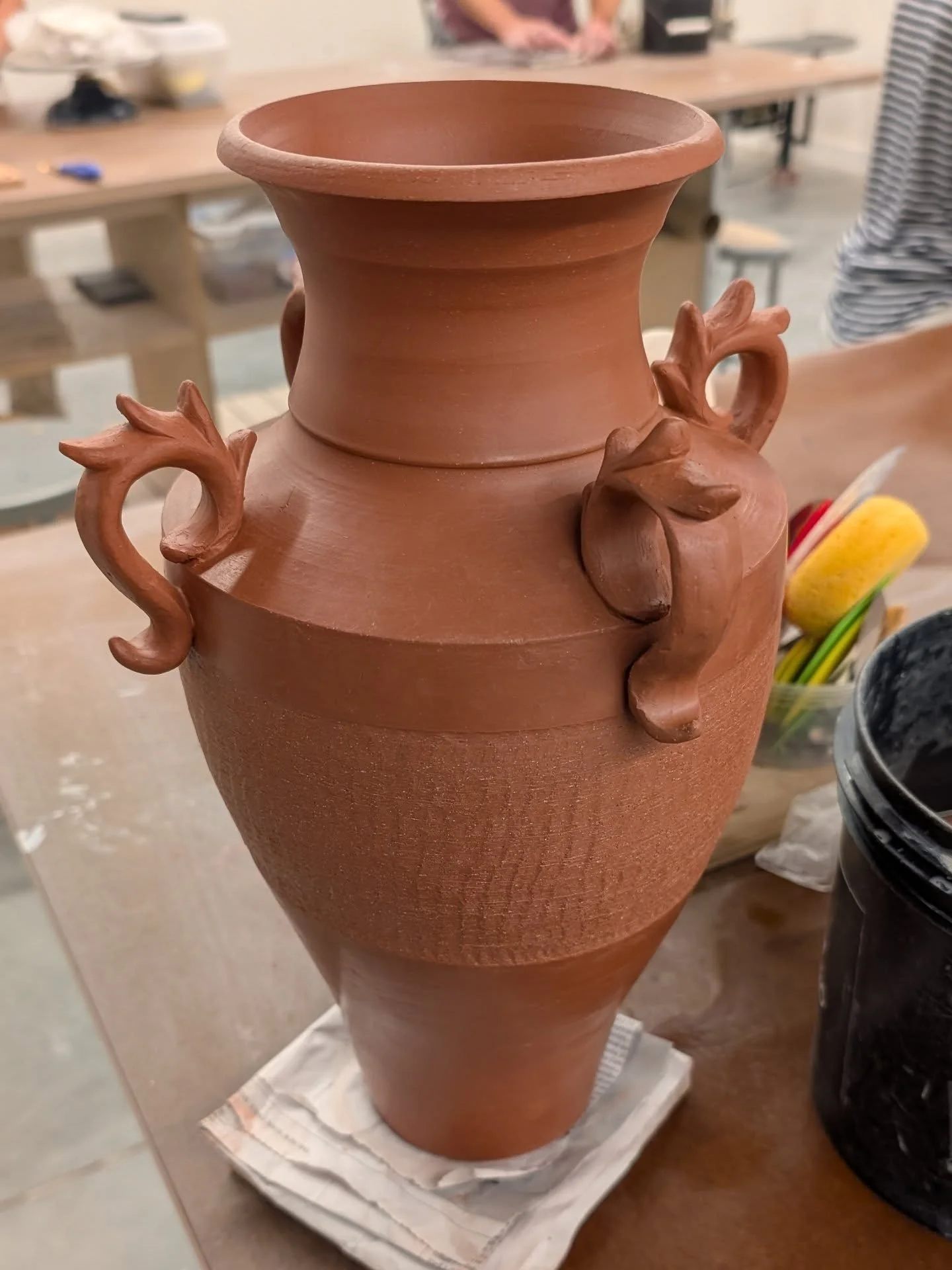 (delayed) Wednesday WIP

I added some small decorative handles to this large pot! I also added some chattering texture along the side. It's currently in the bisque firing!