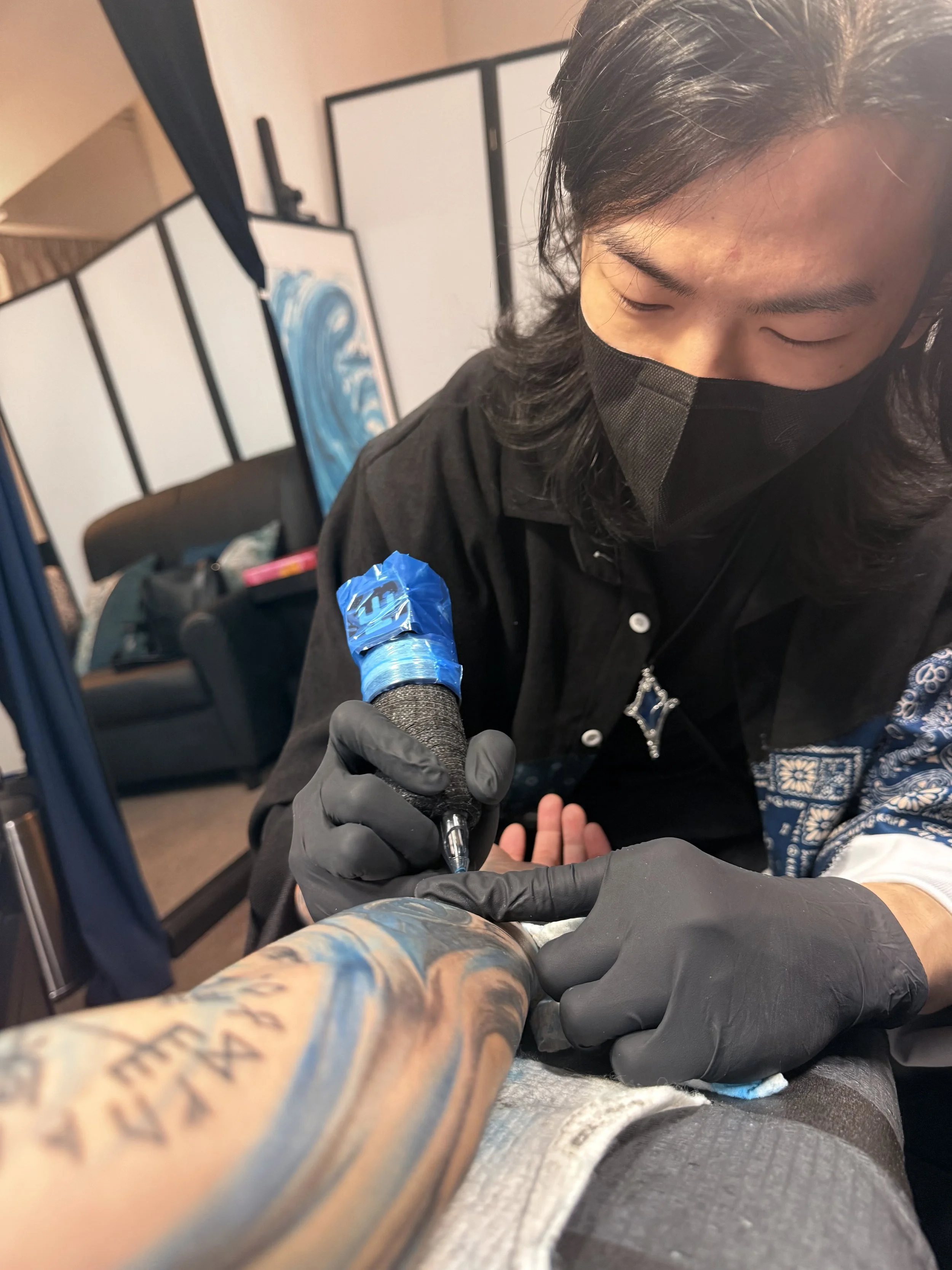 POETAILOR tattoo artist crafting custom arm tattoo in Hong Hong studio