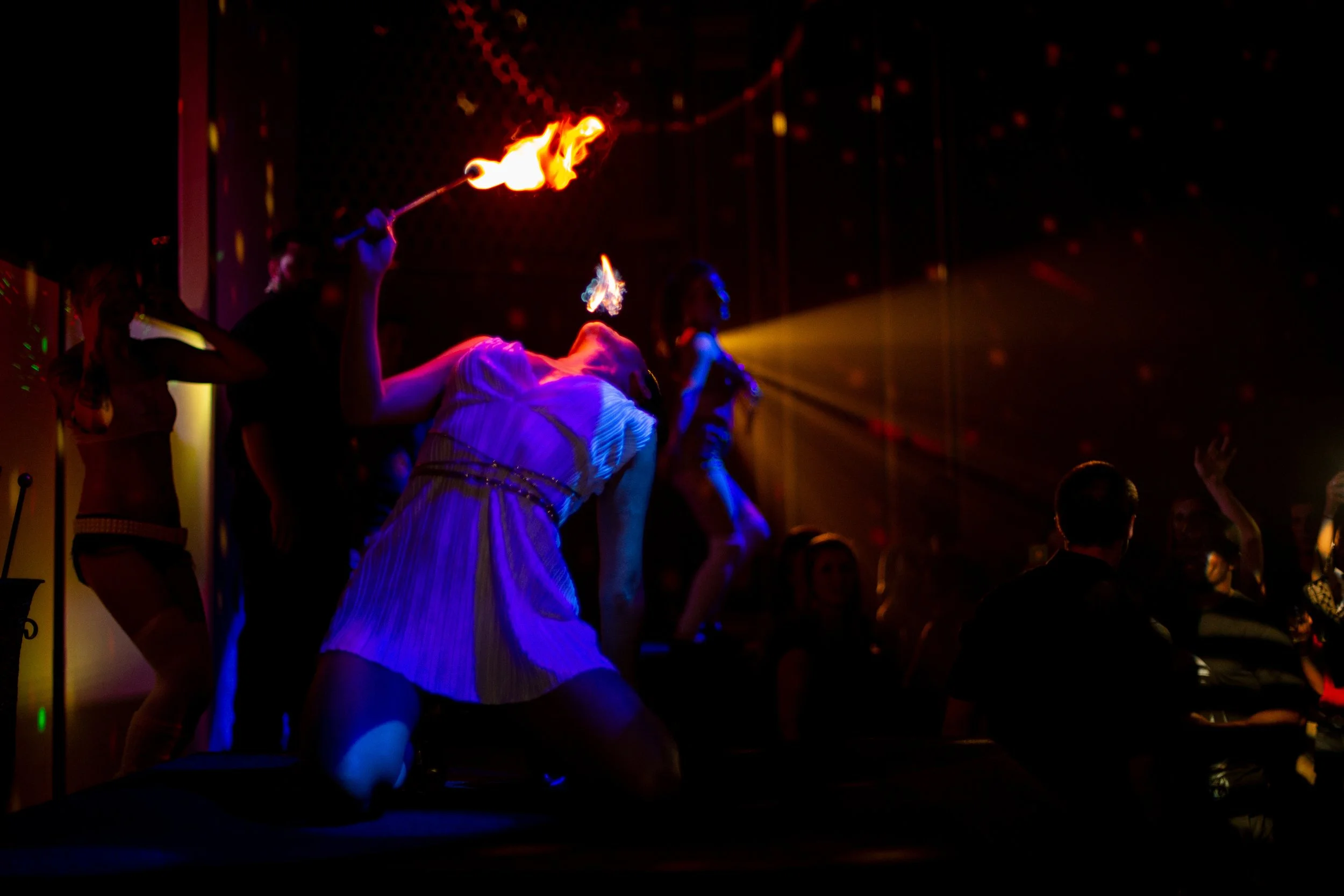 Fire performer in a club with audience watching