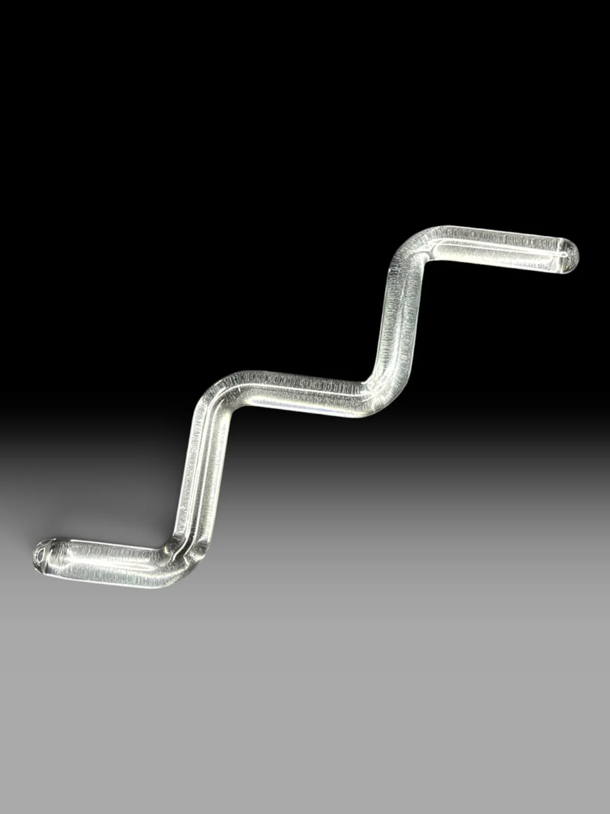 Clear zigzag borosilicate glass stir on a dark background.